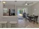 Dining area with table and chairs, opening to a screened-in pool patio with bright natural light at 2759 Starview Ave, North Port, FL 34288