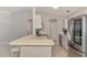 Bright kitchen featuring stainless steel appliances, a breakfast bar, and modern tile flooring at 2759 Starview Ave, North Port, FL 34288