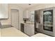 View of bright kitchen with stainless steel refrigerator, stainless steel sink, and tiled backsplash at 2759 Starview Ave, North Port, FL 34288