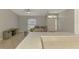 Open living room area with neutral colors, ceiling fan, and view of the entry door at 2759 Starview Ave, North Port, FL 34288