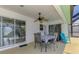 Covered patio with dining table and chairs and view to the pool at 2759 Starview Ave, North Port, FL 34288