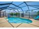Screened-in pool with clear water and a basketball hoop feature, surrounded by patio at 2759 Starview Ave, North Port, FL 34288