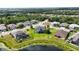 A beautiful home with screened pool sits on a large lot surrounded by green grass and other nice homes at 308 Chantilly Trl, Bradenton, FL 34212