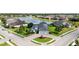 Breathtaking aerial view of a light blue home, by a serene lake, with pristine landscaping at 308 Chantilly Trl, Bradenton, FL 34212