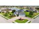 Aerial view of stunning home, lake view, with brick driveway and lush landscaping at 308 Chantilly Trl, Bradenton, FL 34212