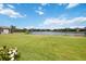 Expansive backyard with lush green lawn and serene lake view, offering a tranquil setting at 308 Chantilly Trl, Bradenton, FL 34212