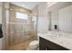 This is a bathroom showcasing a walk-in shower with glass doors and a granite vanity at 308 Chantilly Trl, Bradenton, FL 34212