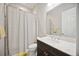 Neutral bathroom featuring a shower with a white curtain and vanity with sink at 308 Chantilly Trl, Bradenton, FL 34212