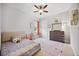 This bedroom features a ceiling fan, large window, and unique wall decorations at 308 Chantilly Trl, Bradenton, FL 34212