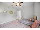 This bedroom includes a ceiling fan, large window, and playful decor at 308 Chantilly Trl, Bradenton, FL 34212