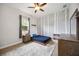 This secondary bedroom showcases a ceiling fan, a white birch tree wall, and a window view at 308 Chantilly Trl, Bradenton, FL 34212