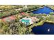 An aerial view of the community pool, tennis courts, playground, and a beautiful lake at 308 Chantilly Trl, Bradenton, FL 34212