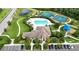 An aerial view of the community pool area with tennis courts, playground, and clubhouse at 308 Chantilly Trl, Bradenton, FL 34212