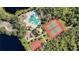An overhead view of the community pool, tennis courts, playground and basketball court at 308 Chantilly Trl, Bradenton, FL 34212