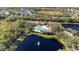 Aerial view of the community pool, tennis courts, playground, and surrounding lakes and neighborhoods at 308 Chantilly Trl, Bradenton, FL 34212