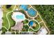 A top-down aerial view of the community pool, clubhouse, tennis courts and playground at 308 Chantilly Trl, Bradenton, FL 34212