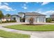 Charming single-story home featuring a three-car garage, lush landscaping, and a well-manicured front lawn at 308 Chantilly Trl, Bradenton, FL 34212