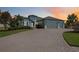 Beautiful single-story home featuring a spacious driveway, a three-car garage, and manicured landscaping at 308 Chantilly Trl, Bradenton, FL 34212
