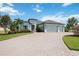 Beautiful single-story home featuring a spacious driveway, a three-car garage, and manicured landscaping at 308 Chantilly Trl, Bradenton, FL 34212