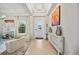 Bright foyer with high ceilings, tile flooring, and a view of the living area with ample natural light at 308 Chantilly Trl, Bradenton, FL 34212