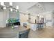 Bright kitchen with white cabinets, stainless steel appliances, backsplash, island, and breakfast table and chairs at 308 Chantilly Trl, Bradenton, FL 34212