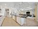 Open-concept kitchen with island and stainless steel appliances, connecting to the living and dining areas at 308 Chantilly Trl, Bradenton, FL 34212