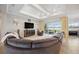 Bright living room with a modern ceiling fan, neutral decor, and sliding glass doors to the outdoor area at 308 Chantilly Trl, Bradenton, FL 34212