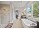 This main bathroom offers a soaking tub and a tiled walk-in shower with dual shower heads at 308 Chantilly Trl, Bradenton, FL 34212
