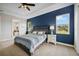 This main bedroom boasts a tray ceiling, a blue accent wall, and carpet flooring at 308 Chantilly Trl, Bradenton, FL 34212
