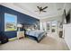 Main bedroom with blue accent wall, ceiling fan, carpet and access to the outdoor living area at 308 Chantilly Trl, Bradenton, FL 34212