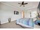 This main bedroom features a plush carpet, tray ceilings, and access to the main bathroom at 308 Chantilly Trl, Bradenton, FL 34212