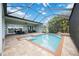 Gorgeous screened pool with a stone waterfall feature and spacious brick patio, ideal for outdoor entertaining at 308 Chantilly Trl, Bradenton, FL 34212