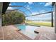 Inviting screened pool with waterfall feature and brick-paved deck, offering a private backyard oasis at 308 Chantilly Trl, Bradenton, FL 34212
