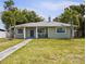 Charming single-story home featuring a well-maintained lawn and inviting front porch seating area at 3102 16Th W Ave, Bradenton, FL 34205