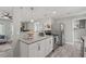 Contemporary kitchen with white cabinetry, stainless steel appliances, and seamless flow into the living area at 3102 16Th W Ave, Bradenton, FL 34205