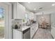 Bright kitchen with white cabinets, granite counters, stainless steel appliances, and dining area at 3102 16Th W Ave, Bradenton, FL 34205