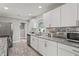 Modern kitchen featuring white cabinetry, granite countertops, and stainless steel appliances at 3102 16Th W Ave, Bradenton, FL 34205