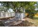 A metal shed in the backyard surrounded by mature trees, offering ample storage space and functionality at 3102 16Th W Ave, Bradenton, FL 34205