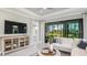 Cozy living room with large windows and sliding doors to screened in patio at 3118 Torta Ct, Bradenton, FL 34211
