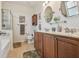 Bright bathroom with a double vanity, framed mirrors, shower, and tile floors at 327 64Th Avenue E Cir, Bradenton, FL 34203