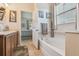 Bathroom with a soaking tub and an open doorway to the main bedroom at 327 64Th Avenue E Cir, Bradenton, FL 34203