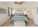 Bedroom with neutral carpet, ceiling fan, ensuite bathroom and walk in closet at 327 64Th Avenue E Cir, Bradenton, FL 34203
