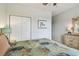 Bright bedroom featuring a closet, dresser, and large window at 327 64Th Avenue E Cir, Bradenton, FL 34203