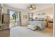 Bright bedroom with ceiling fan, ensuite bathroom and sliding glass door to lanai at 327 64Th Avenue E Cir, Bradenton, FL 34203