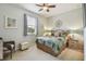 Cozy bedroom with a ceiling fan, window with blinds, and carpet flooring at 327 64Th Avenue E Cir, Bradenton, FL 34203