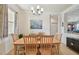 Bright dining room featuring a chandelier, light wood table, and artwork at 327 64Th Avenue E Cir, Bradenton, FL 34203