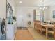 Cozy dining area featuring a chandelier, window, and view of the front door at 327 64Th Avenue E Cir, Bradenton, FL 34203