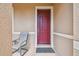 Inviting entryway featuring a striking red front door, seating area, and decorative accents at 327 64Th Avenue E Cir, Bradenton, FL 34203