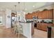 Open kitchen with stainless appliances, granite counters, wood cabinets, and bar stool seating at 327 64Th Avenue E Cir, Bradenton, FL 34203