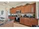 Spacious kitchen featuring wood cabinets, granite countertops, and stainless steel appliances at 327 64Th Avenue E Cir, Bradenton, FL 34203